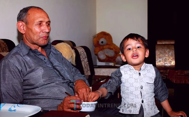 Grandparent with a grandchild at home