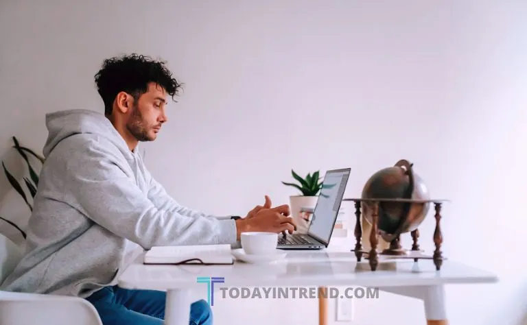 Remote employee working on a laptop at a home office desk