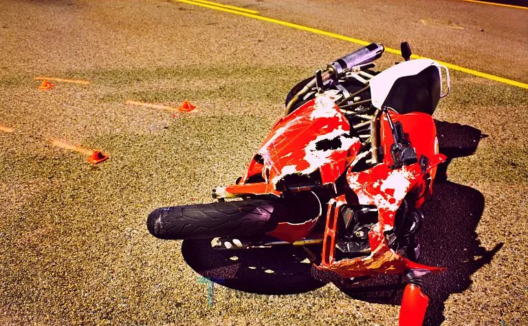 Damaged motorcycle on the road after a crash