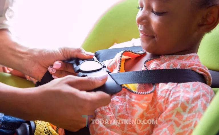 Child sitting in a booster seat in the back seat of a car